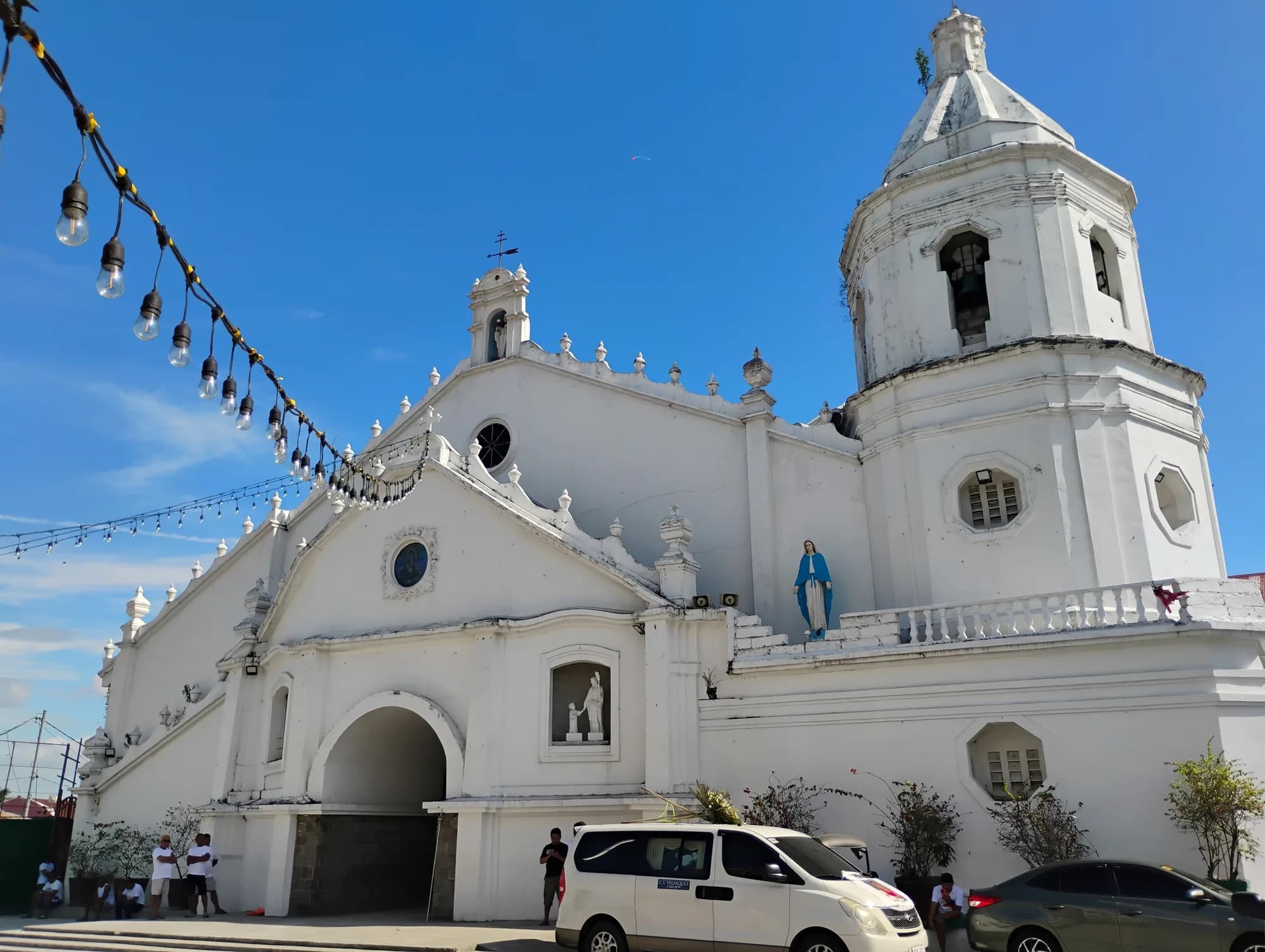 White facade and bell tower of Santa Lucia Parish Church, Sasmuan